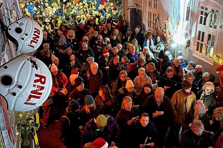 Crowds pack into Minehead RNLI station for 'Carols in the Boathouse'.