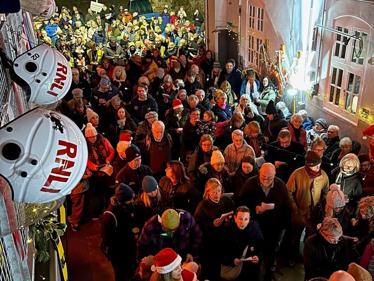 Crowds pack into Minehead RNLI station for 'Carols in the Boathouse'.
