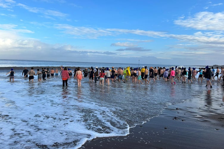 Dippers entering the water at Minehead Beach on New Year's Day to raise funds for St Margaret's Hospice.