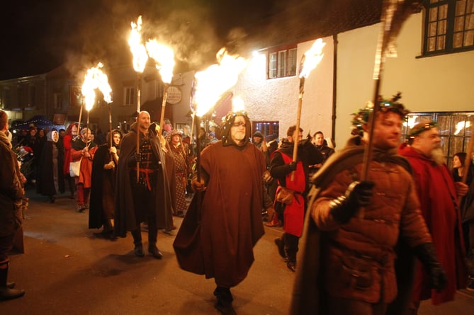 Mitchell and Vincent with their flaming torches during the 2023 Dunster by Candlelight festival.