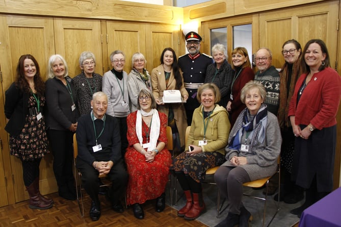 Volunteers and trustees of the West Somerset Food Bank celebrate the presentation of the Kings Award for Voluntary Service with Lord Lieutenant of Somerset Mohammed Saddiq.