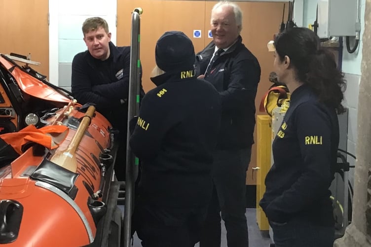 RNLI chief executive Mark Dowie (centre) with Minehead crew (left to right) Harry Mouzouri, Karla Thresher, and Raji Webber.