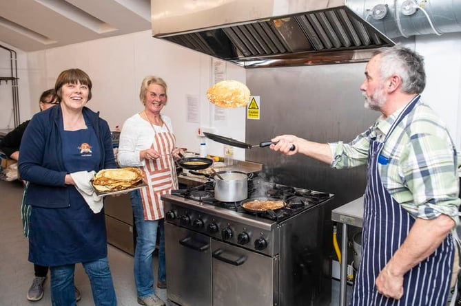 Cooking pancakes in Brompton Regis raised £600 for Dorset and Somerset Air Ambulance.