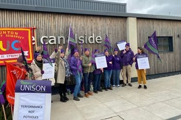 Union members protest budget cuts outside a meeting of Somerset Council.