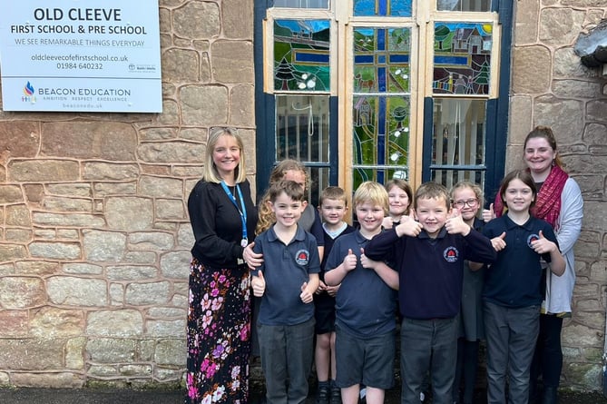 Old Cleeve Church of England First School headteacher Emma Murch (left) and religious education leader Abby Needs with pupils celebrating their SIAMS report.