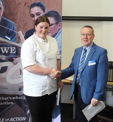 Young chef Katrina Nightingale receiving her award from Rotary district governor Stuart Gilbert.