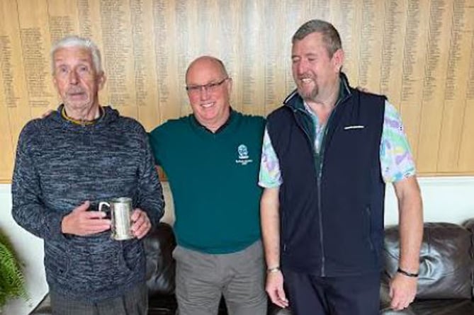 Presentation of the Trafalgar Tankard. Centre: Minehead Seniors' Captain Martyn Westbury (centre) presenting the Tankard to Roger Green (left)  and Dave Oatridge (right).