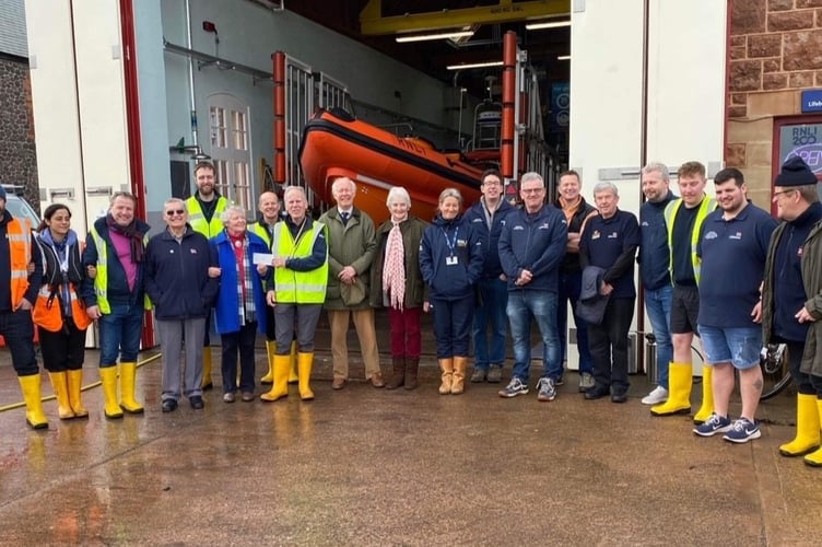 Anna Connell and family present a cheque for £15,045 to the Minehead RNLI Jeremy