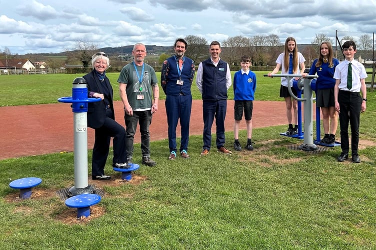 Pictured with the outdoor gym equipment are (left to right) Summerfield sales advisor Rene Kilner, school caretaker Ray Griffiths, headteacher David McGrath, Summerfield divisional director for sales and marketing Philip Morgan, with pupils Freddie, Isabelle, Tammy, and Freddie. Danesfield School Williton