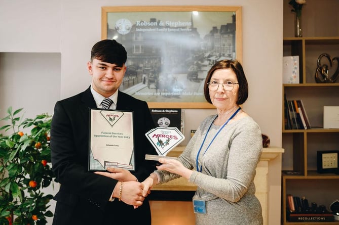 Orlando Levy, of Robson and Stephens Funeral Services, Minehead, receives his funeral care apprentice of the year award.