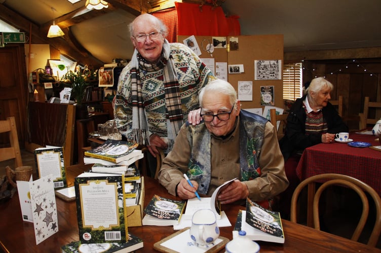 Powers Ian Mawby signs a copy of his book for artist David Jessup.