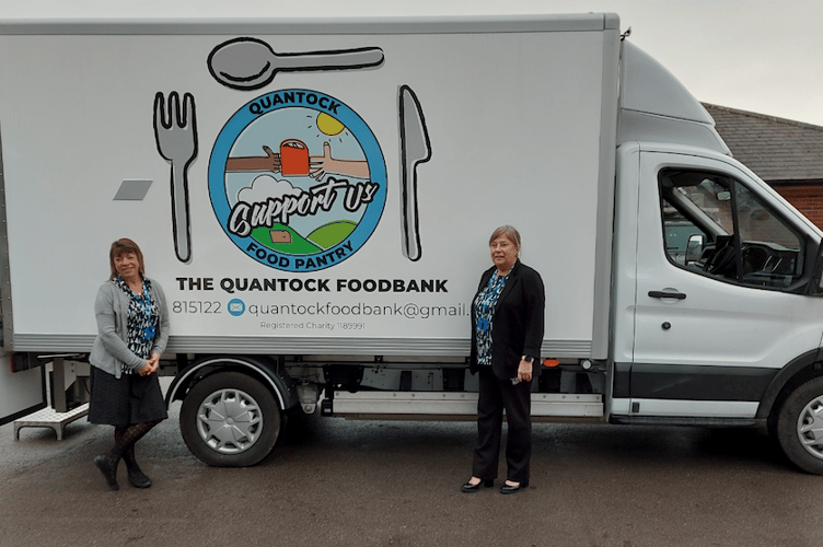 Quantock Foodbank's electric truck collecting donations from Williton Surgery with medical secretary Caron Page (left) and senior receptionist Kim Shortland.