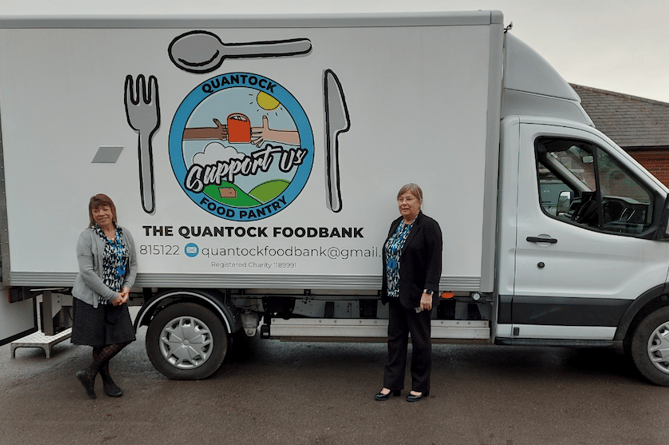 Quantock Foodbank's electric truck collecting donations from Williton Surgery with medical secretary Caron Page (left) and senior receptionist Kim Shortland.
