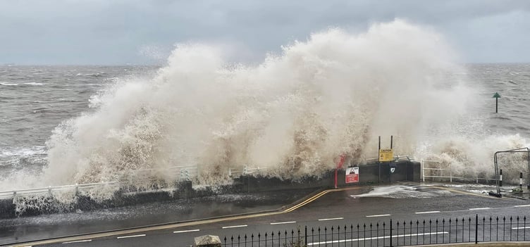 Strong winds drive a high tide onto the sea wall at Blue Anchor.