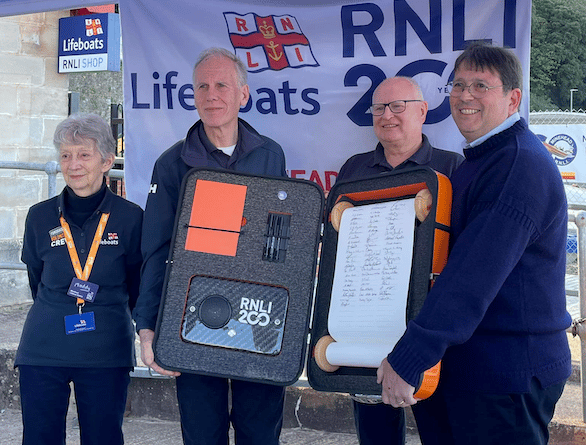 Pictured with the RNLI 200th commemorative scroll at Minehead Lifeboat Station are (left to right) fund-raising volunteer Maddy Taylor, lifeboat operations manager John Higgie, shop volunteer Phil Pegg, and station chairman Richard Newton.