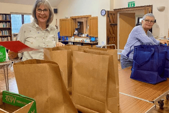 West Somerset Food Cupboard volunteers sorting food parcels for needy families.