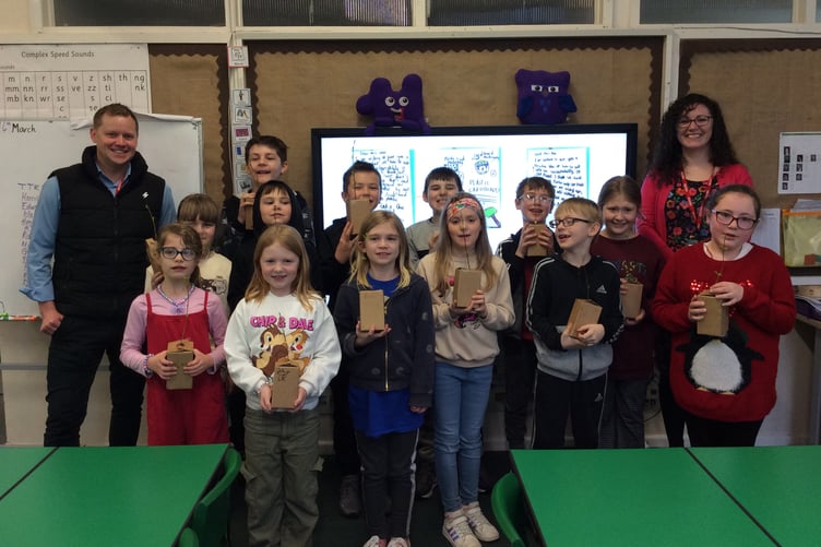 Pupils of Robins class in Beech Grove School, Wellington, with their 'tree in a box' planted with RH Fibreboard sales director Steve Gabell (left).