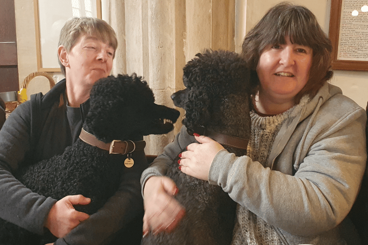 St Petrock’s, Timberscombe, churchwarden Kate Hart (left) with her poodles Toddy and mum Jemima, and Adele Wealleans.