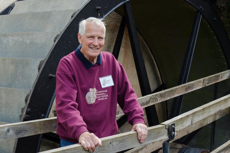 The late Owen Rush, pictured next to Cowbridge Sawmill waterwheel, Timberscombe.