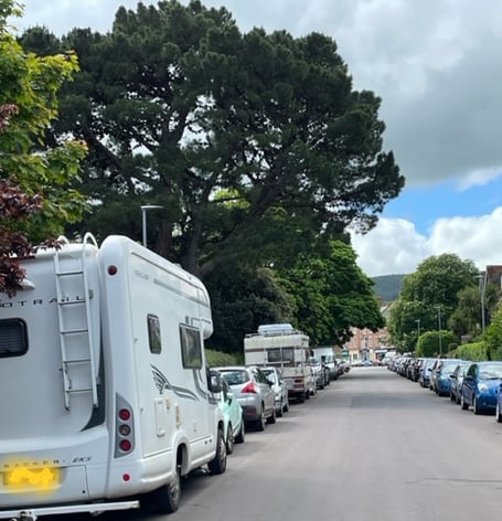 A number of motorhomes can be seen parked along Blenheim Road, Minehead.