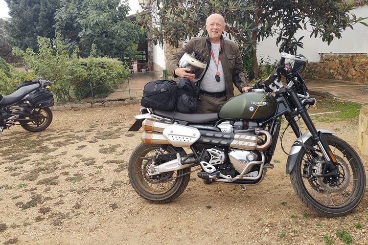 Stogursey Motors owner George Brockis with his Triumph Scrambler motorcycle.