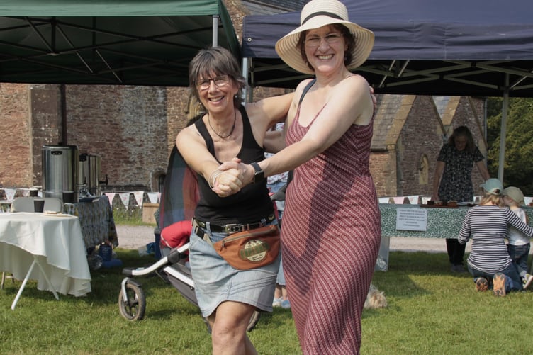 Jackie Heard and Angela Wood dance to the music at Nettlecombe church fete.