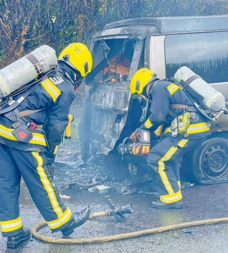A car fire being tackled by a Devon and Somerset Fire and Rescue crew.