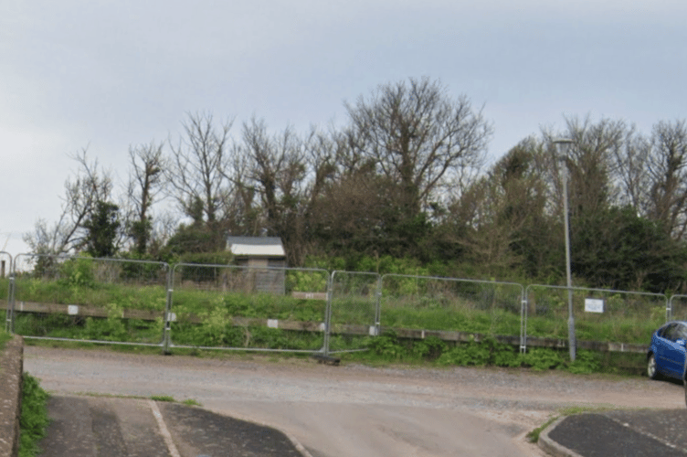 The clifftop and abandoned allotments fenced off in the West Street car park, Watchet. 