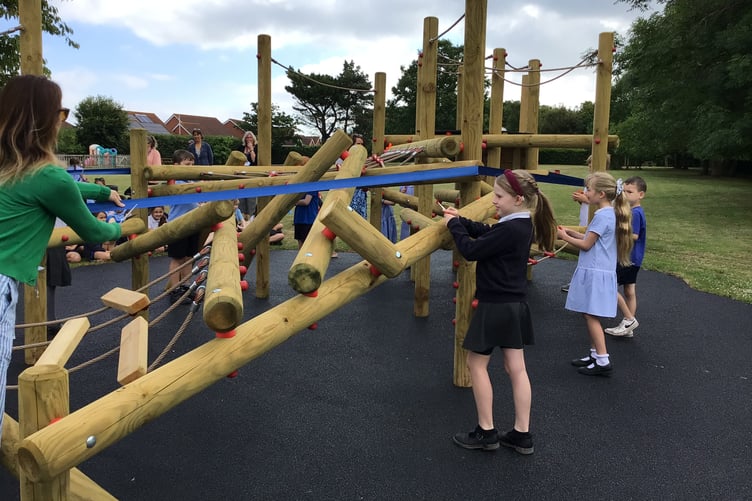 School council members prepare to cut a ribbon to open new playground equipment at Knights Templar School, Watchet.