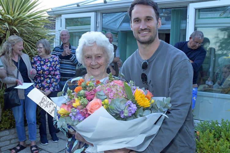 Somerset captain Lewis Gregory presents Mary Elworthy with a bouquet at her last-ever barbecue which raised a record £6,000.