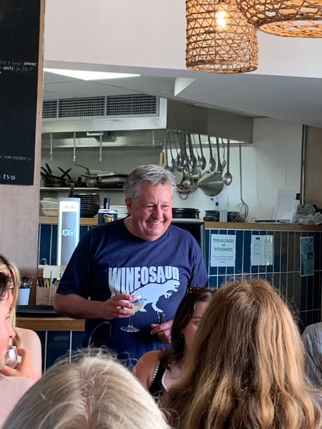 Geckoella's Dr Andy King presenting a Watchet geology and wine evening in his 'Wineosaur' T-shirt.