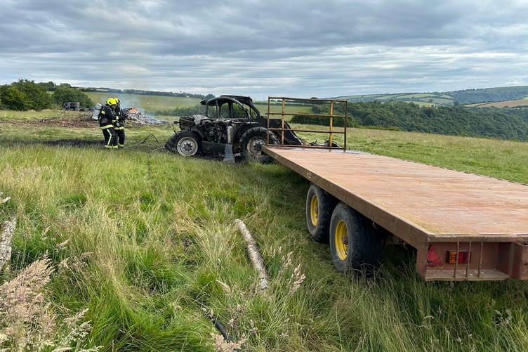 Firefighters tackle a telehandler which caught alight in an Exmoor field.