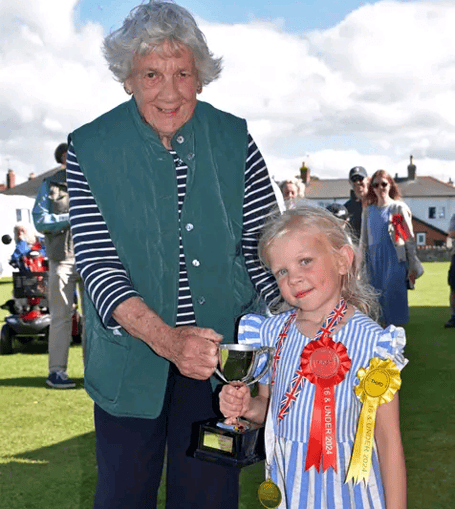 Val Norman donated a trophy to Watchet Gardening Club in memory of her late husband Keith and presented it to the children's 'Best in Show' winner Tilly Jukes. PHOTO: Peter Mather.