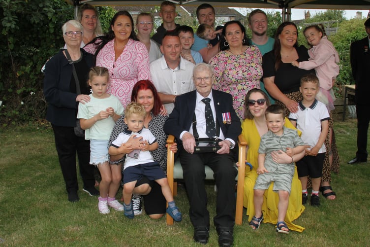 Proud Watchet war veteran George Lewis is surrounded by family after receiving his Second World War medals nearly 80 years late. Daughter Liz is on the left.
