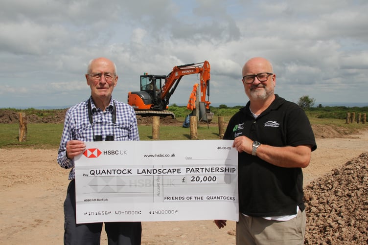Pictured is Friends of the Quantocks chairman John Andrews (left) presenting a cheque to Quantock Landscape Partnership Scheme manager William Jenman. PHOTO: George Ody.