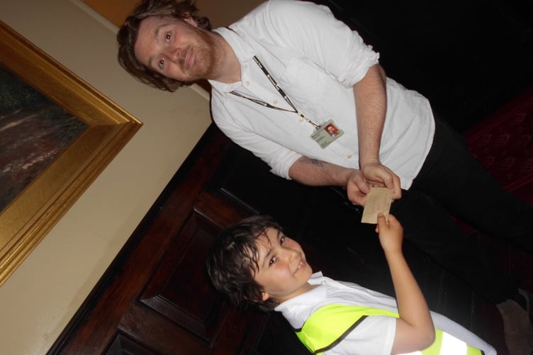 Dunster Castle events programming and partnerships manager Barney Kenny is handed keys to three 'time capsules'.