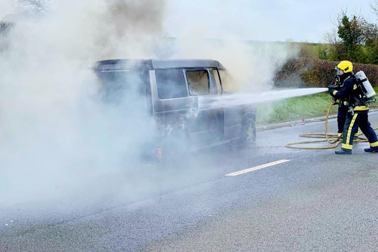 A vehicle fire being tackled by a Devon and SomersetFie and Rescue Service crew.