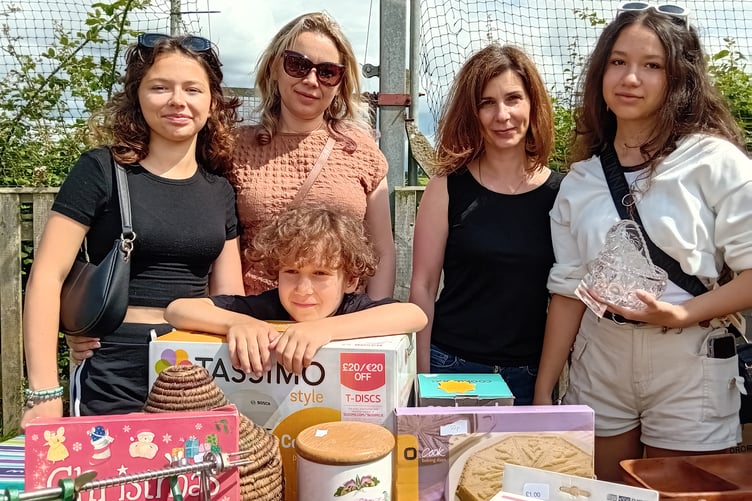 Ukrainian visitors browsing through the bric a brac stall at Fitzhead fete, left to right, Ksusha Kahal, Tanya Wyshneva, Tanya Gonchar, Anya Salo, with Andrey Salo (centre). PHOTO: Sue Mitchison.