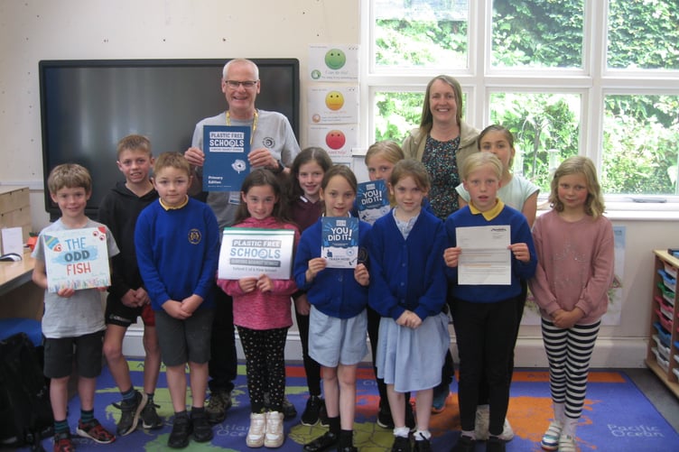 Plastic Free Exmoor community lead Peter Hoyland presents the Surfers Against Sewage award to Exford First School.
