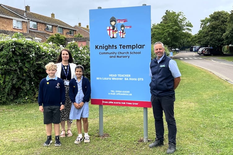 Pictured in front of the new school gates are Knights Templar headteacher Mrs Laura Weaver, pupils Mackenzie and Deana, and Summerfield projects manager Mark Woodland.