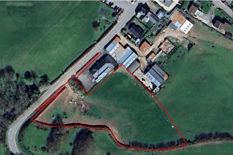 An aerial view of the site outlined in red where a new housing development has been proposed behind the Moorland Hall, Wheddon Cross. PHOTO: Polden Planning.