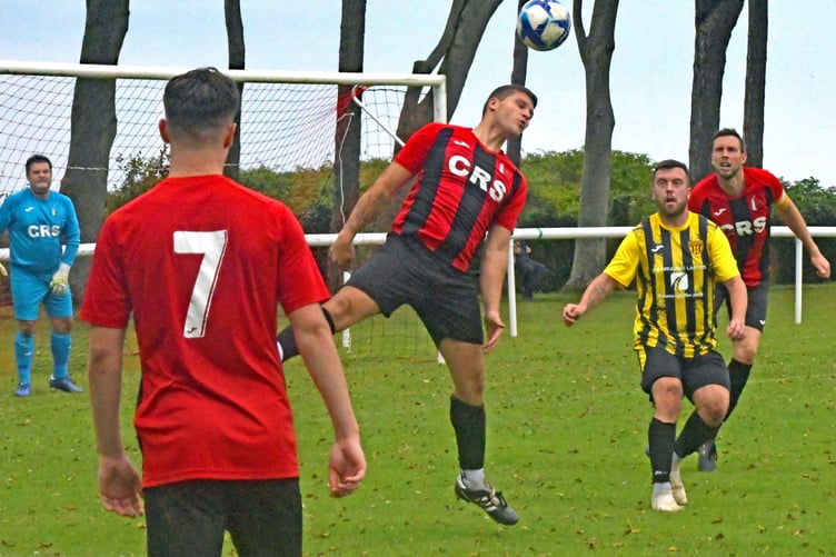 Watchet keeper Vinnue Jones looks on as Charley Clausen heads clear