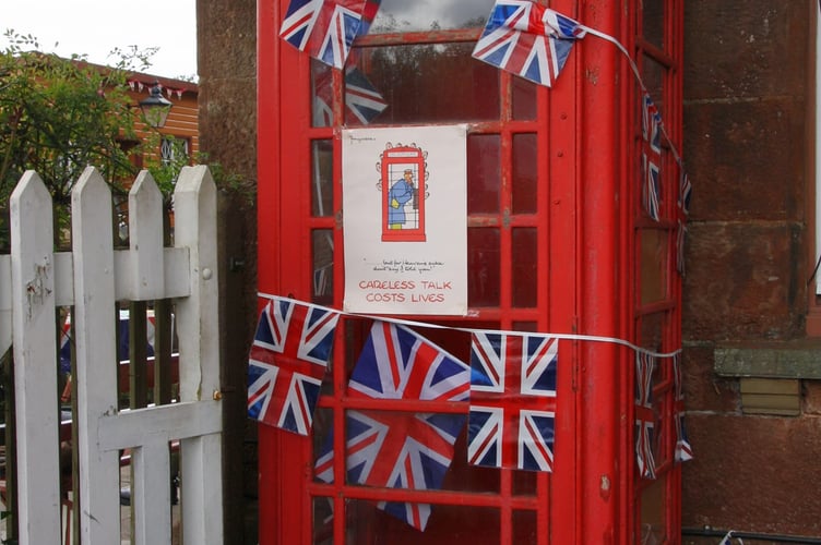 A decorated telephone box with the warning Careless Talk Costs Lives