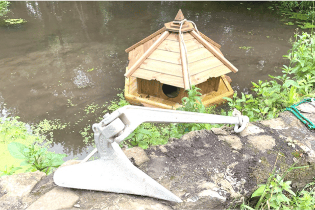 The duck house and its former sailing yacht anchor in Kilve.