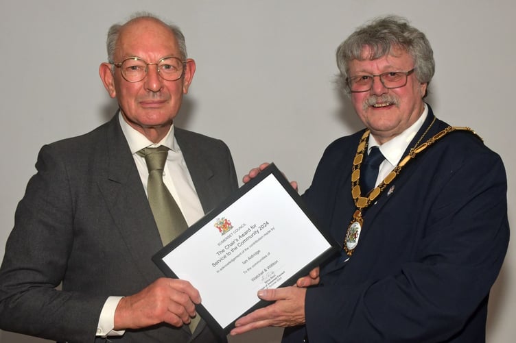 Williton Parish Council vice-chairman Cllr Ian Aldridge (left) receives a community award from Somerset Council chairman Cllr Mike Best. PHOTO: Alain Lockyer.