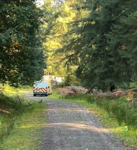 Vehicles can be see parked at the side of a track leading into Croydon Woods, on Exmoor, where an illegal rave was hellcat the weekend.