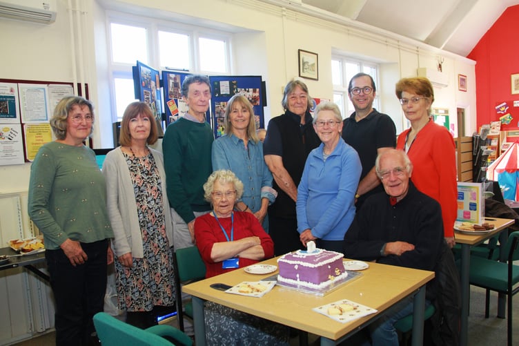 Celebrating Porlock Community Library's 10th anniversary are (left to right) standing - original library officer Jan Stapleford, Minehead chief librarian Sara Long, parish council chairman Cllr Duncan McCanlis, Cllr Sue McCanlis, Anne Looney, former councillor Margaret McCoy, parish clerk Johnathan Jones, and library officer Mary Perkins. Front – volunteers Shirley Butler and Malcolm McCoy, who was a councillor at the time of set up.