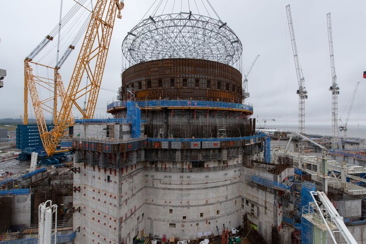 Big Carl, the world's largest land-based crane, lifts a final steel liner ring into position in the second reactor building at Hinkley Point C. PHOTO: EDF.