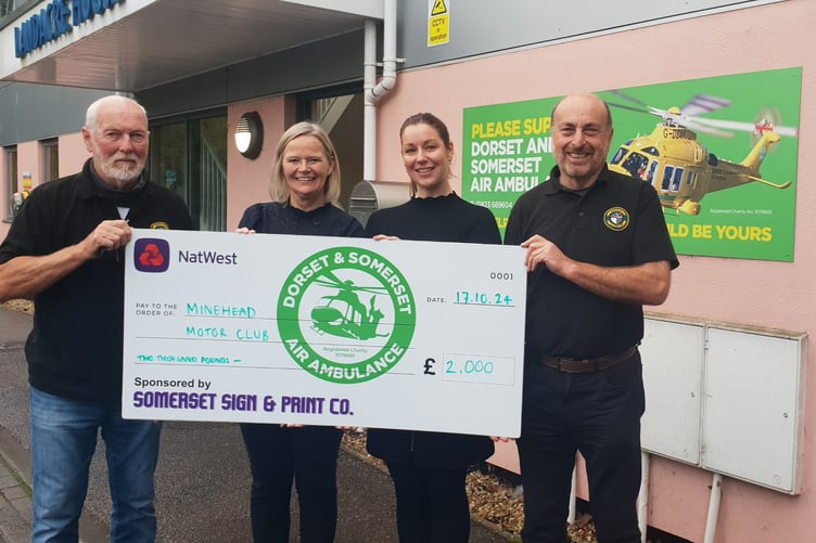 Minehead Motor Club secretary Richard Williams presents a £2,000 cheque to Dorset and Somerset Air Ambulance deputy chief executive Julie Plowden with charity supporter engagement officer Charlotte Humber and club vice-chairman Clive Rayson.