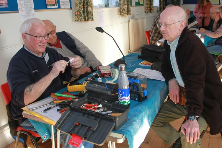 Alan Elliot (left) fixing table lamp holders for Stephen King at the first Minehead Repair Cafe. PHOTO: George Ody.